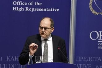 Visoki predstavnik Christian Schmidt govori na konferenciji za medije ispred plavog pozadinskog panela s logom Ureda visokog predstavnika (OHR) u BiH.